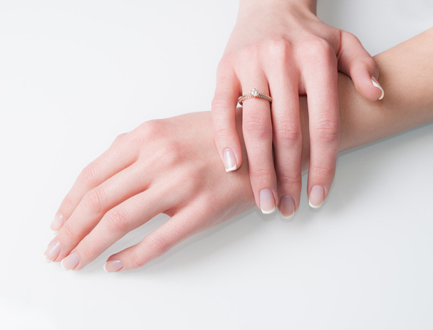 Woman hands with engagement ring on white - Фото, зображення