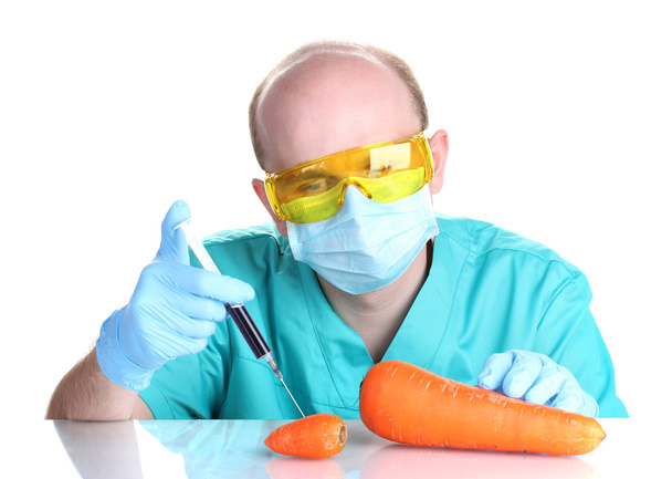 Scientist injecting GMO into the carrot - Zdjęcie, obraz