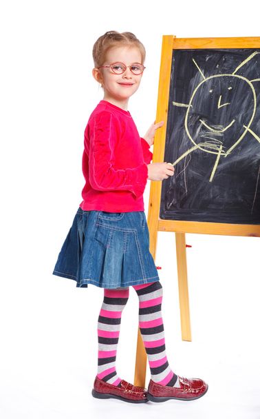 Little girl draws on the board - Фото, изображение