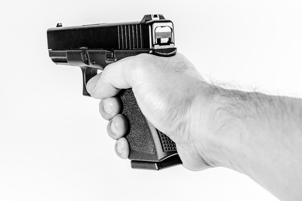 firearm gun in hand  - Foto, afbeelding