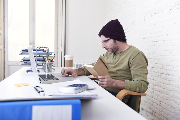 young attractive hipster businessman working from his home office as freelancer self employed business model - 写真・画像