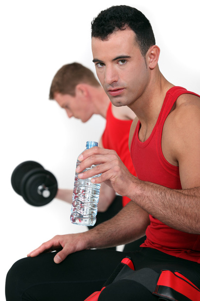 Two men working out at the gym - Photo, image