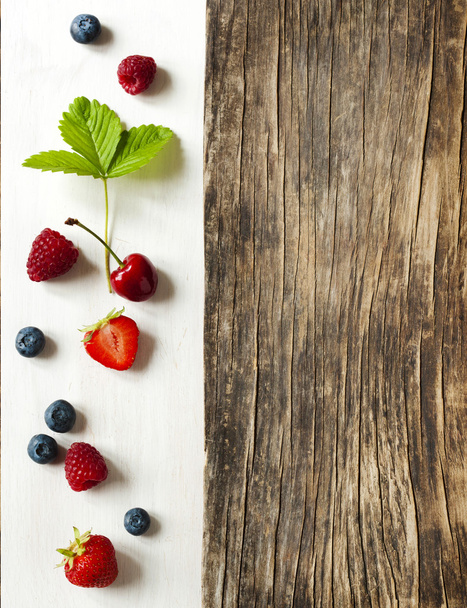 Wooden background with summer berries and copy space - Foto, Bild
