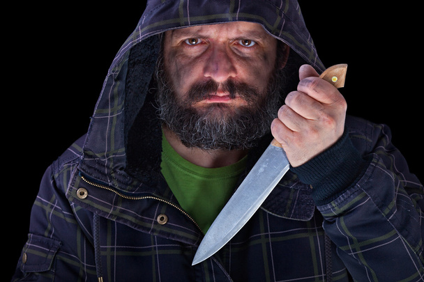 З капюшоном переляканий чоловік з брудним обличчям і великим ножем
 - Фото, зображення