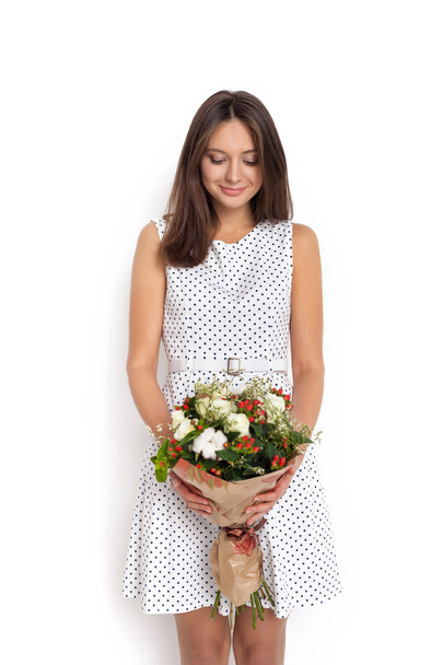 Young cute woman holding bunch of flowers - Fotoğraf, Görsel