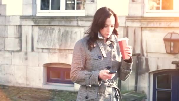 Attractive Businesswoman outdoor with mobile phone and coffee - Filmmaterial, Video