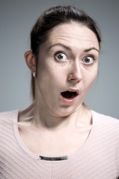 Portrait of young woman with shocked facial expression - Foto, Bild
