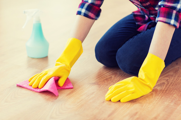 close up of woman with rag cleaning floor at home - Foto, immagini
