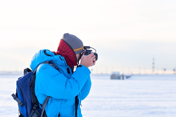photographer in blue jacket outdoors - Фото, изображение