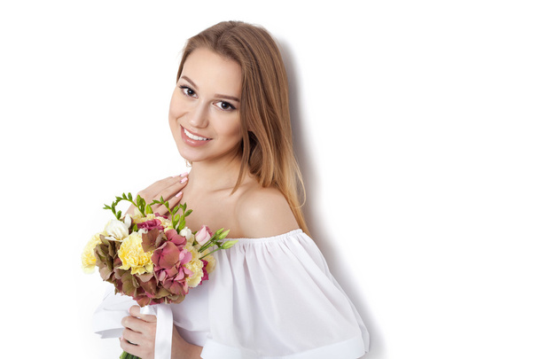 Young cute woman holding bunch of flowers - Фото, зображення