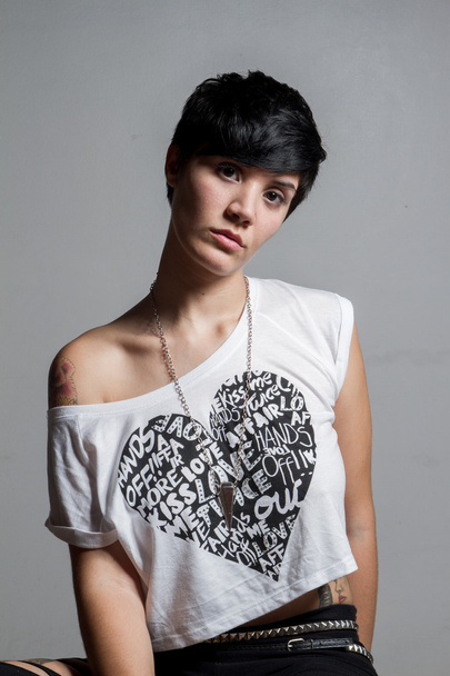 Beautiful short-hair brunette woman seated, looking at camer - 写真・画像