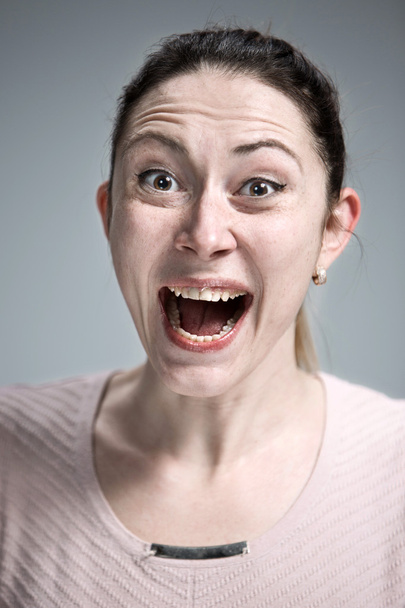 Portrait of young woman with shocked facial expression - Photo, image