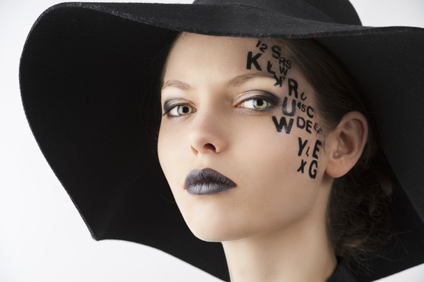 The letter on the face creative makeup girl, close-up portrait - Fotografie, Obrázek