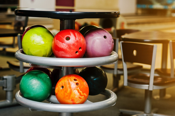 Many colored balls for bowling at table to store - 写真・画像