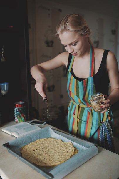 Жінка готує піцу на кухні
 - Фото, зображення