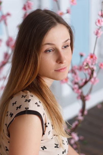 Beautiful girl with long hair in flowering garden - Fotografie, Obrázek