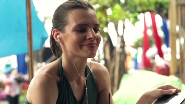 woman listen music in beach bar - Video