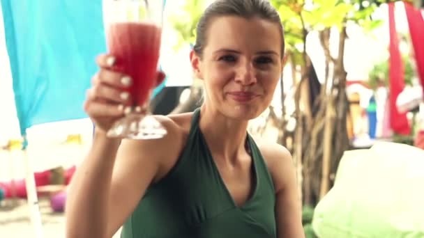 woman raising toast and drinking cocktail - Filmati, video