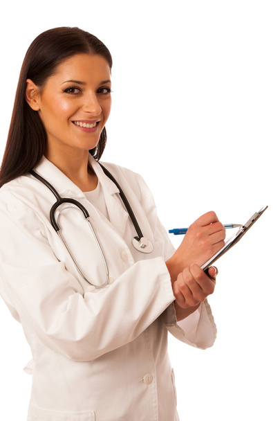 Woman doctor with stethoscope around neck writing diagnose on cl - Foto, Imagen
