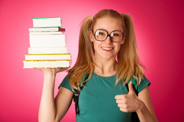 Curious, naughty, playful schoolgirl with stack of books and big - Fotoğraf, Görsel