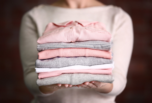 Woman holding washed and dried clothes  - Photo, Image