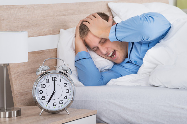 Sleeping Man with Ringing Alarm Clock - Fotó, kép