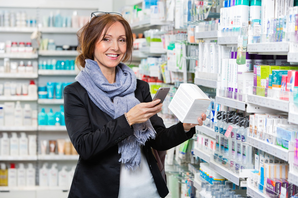 Smiling Customer Scanning Product Through Smart Phone In Pharmac - Foto, Imagem