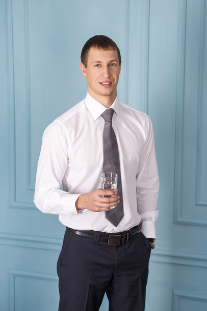 Feeling comfortable. Handsome smiling man and holding a glass of - Fotografie, Obrázek