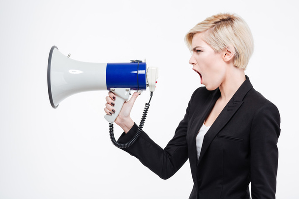 Businesswoman screaming into megaphone - Photo, image