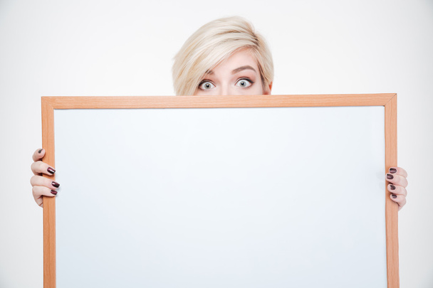 Blonde woman peeking from blank board - Photo, Image