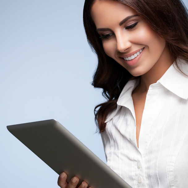 businesswoman using no-name tablet pc, over grey - Fotografie, Obrázek