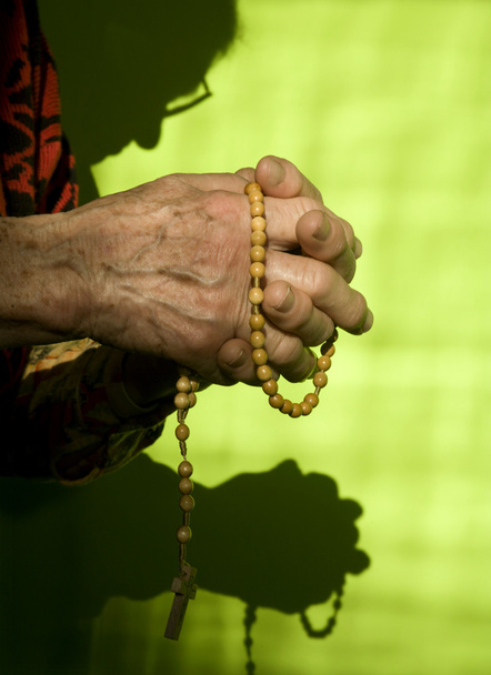 Manos de anciana rezando rosario
 - Foto, imagen