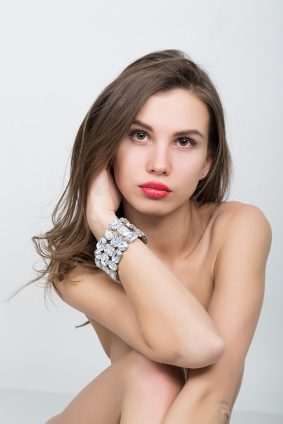 close-up portrait of a beautiful girl with red lips, brilliant bracelet on the wrist. Red Sexy Lips and Nails closeup - Fotoğraf, Görsel