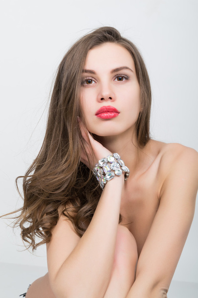 close-up portrait of a beautiful girl with red lips, brilliant bracelet on the wrist. Red Sexy Lips and Nails closeup - Fotografie, Obrázek