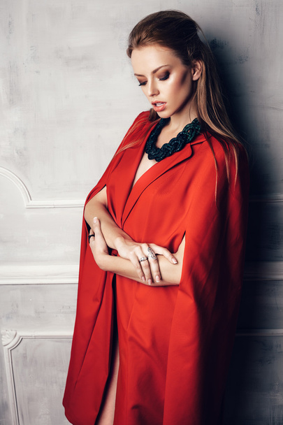 Fashion young beautiful woman in red coat - 写真・画像