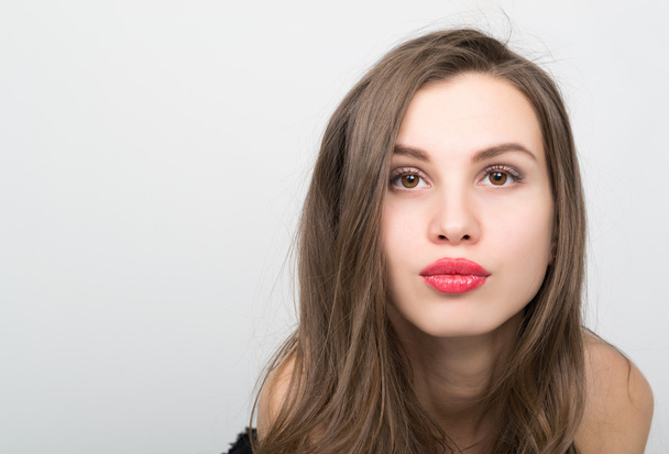 close-up portrait of a beautiful brunette girl with red lips, expresses different emotions - Photo, image