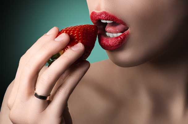 Sexy lips with strawberry. White teeth and skin. Green backgroun - Foto, Imagen