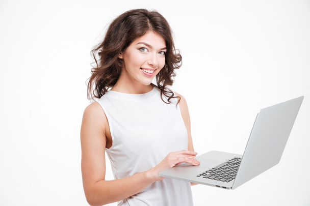 Smiling woman using laptop computer - Φωτογραφία, εικόνα