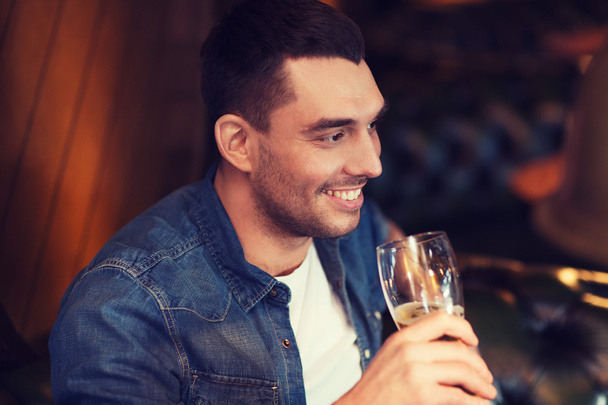 happy man drinking beer at bar or pub - Zdjęcie, obraz