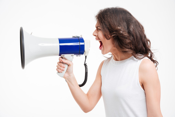 Woman screaming into megaphone - Foto, imagen