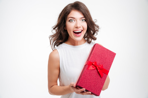 Cheerful woman holding gift box - Фото, изображение