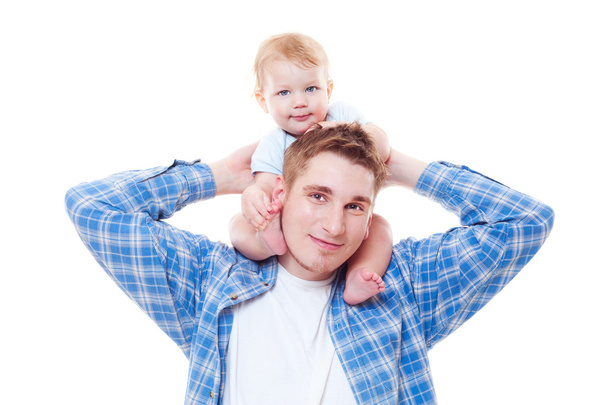 Studio shot of little boy sitting on shoulders of his father - Photo, Image