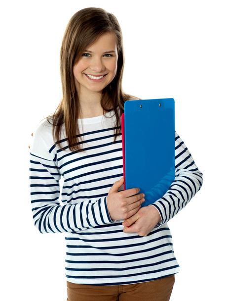 Smiling cute trendy girl holding documents and posing - Фото, изображение