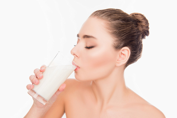 Healthy young woman drinking milk shake on white background - Фото, зображення