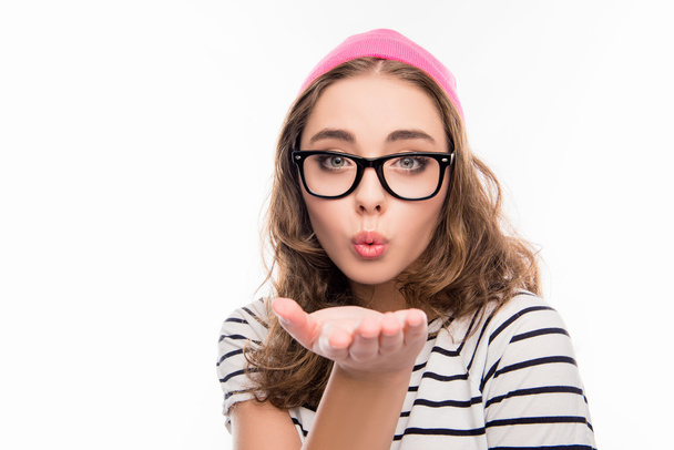 Portrait of cute  girl in hat and glasses sending air kiss - Foto, Imagen