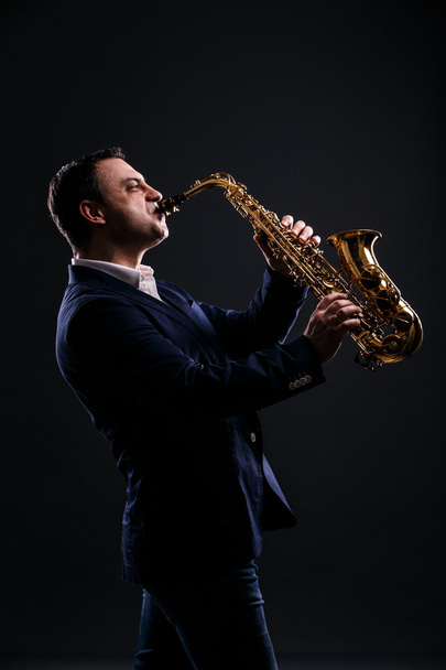 musician plays jazz at saxophone - Foto, afbeelding