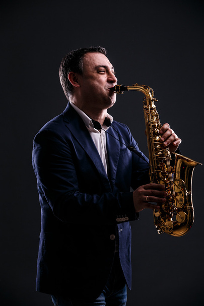 musician plays jazz at saxophone - Фото, изображение