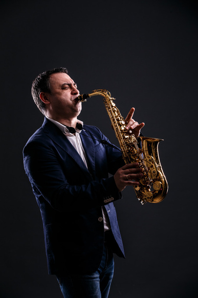 musician plays jazz at saxophone - Foto, immagini