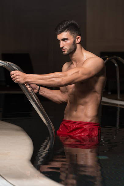 Young Man Swimming In Pool At Resort - Fotografie, Obrázek