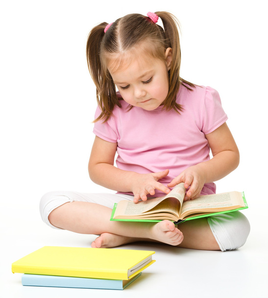 Cute little girl reads a book - Zdjęcie, obraz